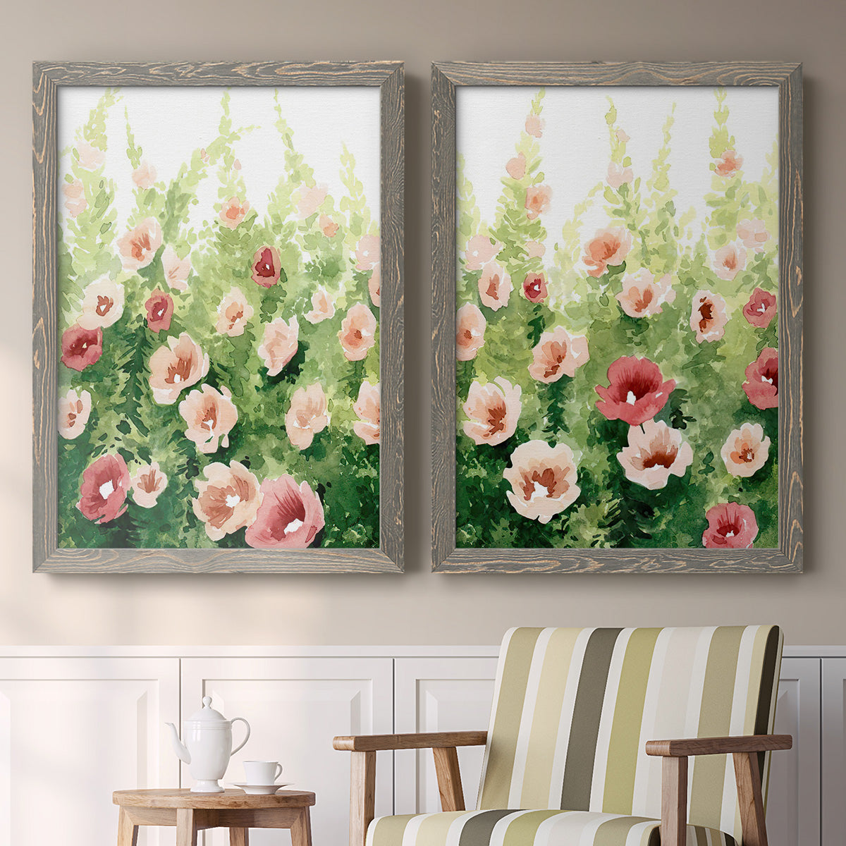 Set of two gray barnwood framed canvas prints depicting two luminous impressionistic floral paintings featuring a field of pink coral and white flowers above a sideboard in a cozy sitting room.