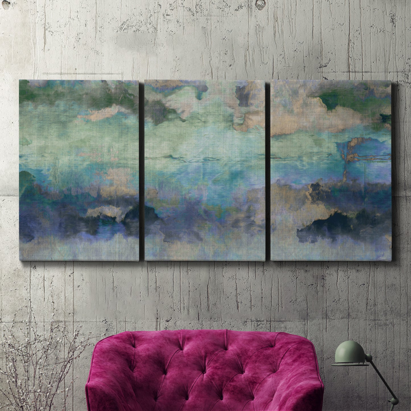 Three-panel canvas wall art featuring cool dreamy abstraction, displayed in a living room above a suede accent chair.