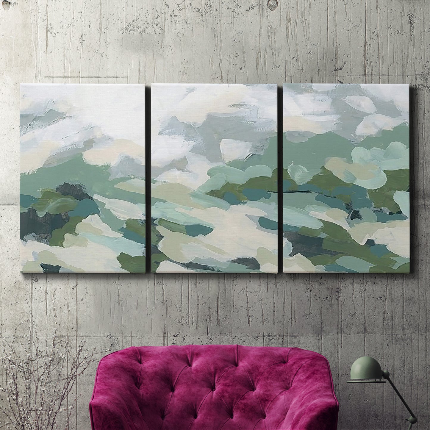 Three-panel canvas wall art featuring lush green hillside rolling landscape, displayed in a living room above a suede accent chair.