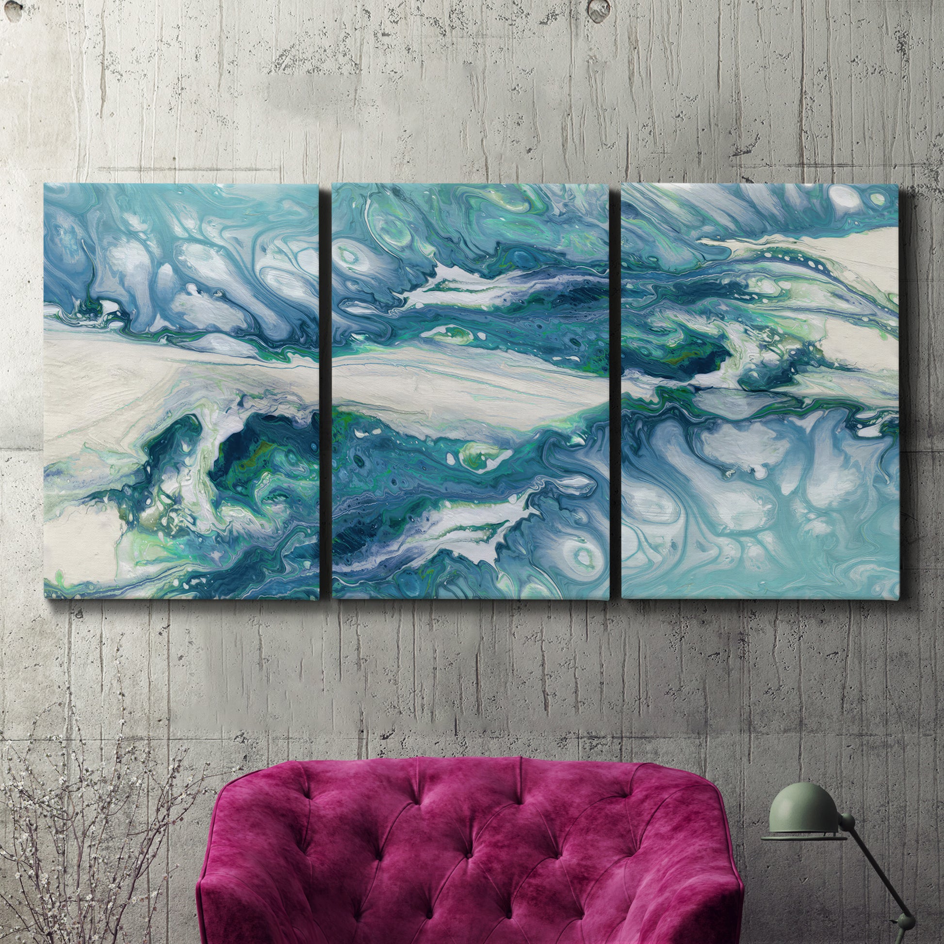Three-panel canvas wall art featuring layered abstract marble textures, displayed in a living room above a suede accent chair.
