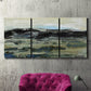 Three-panel canvas wall art featuring muted abstract landscape study, displayed in a living room above a suede accent chair.