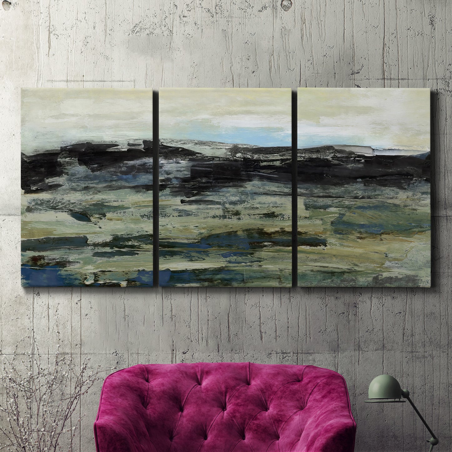 Three-panel canvas wall art featuring muted abstract landscape study, displayed in a living room above a suede accent chair.