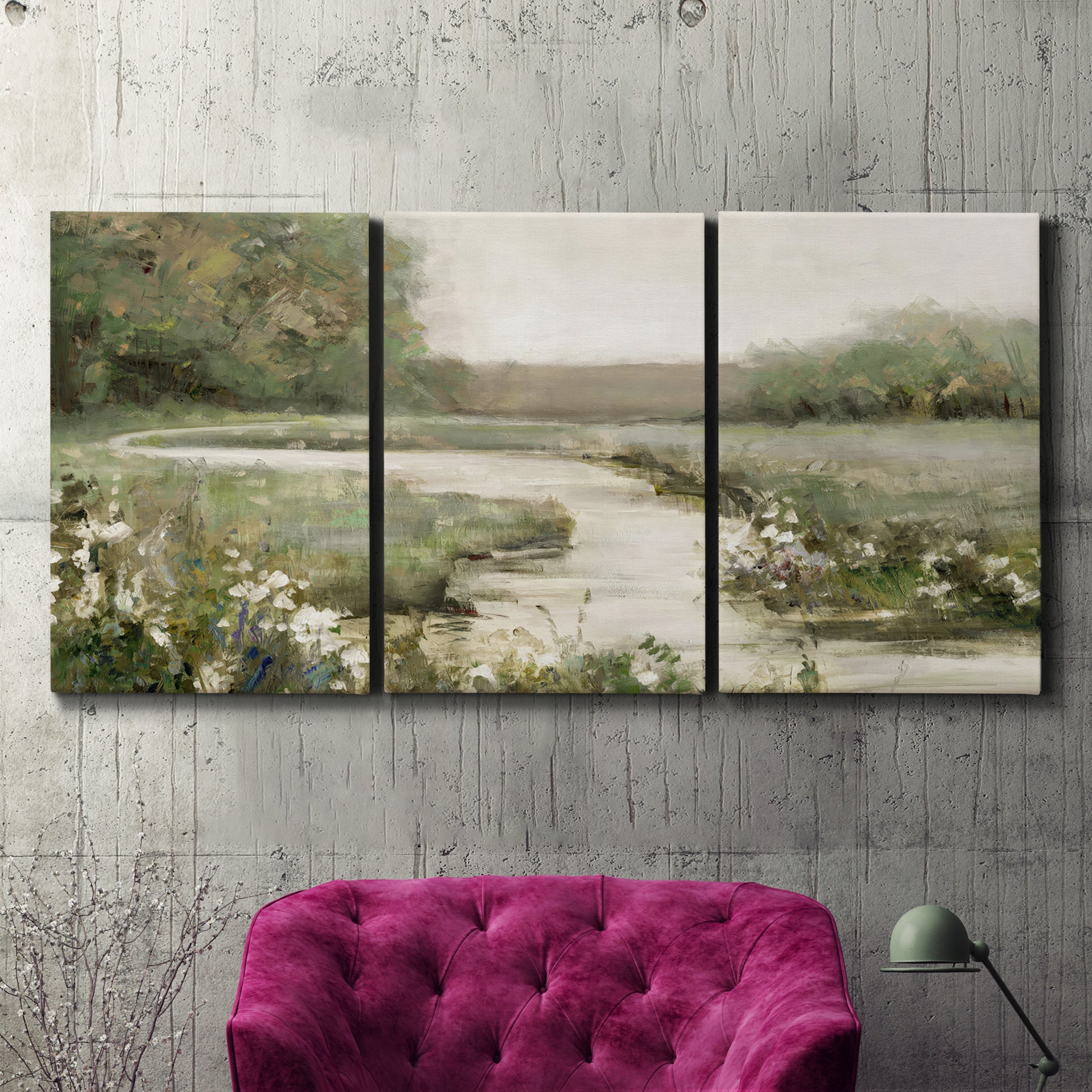 Three-panel canvas wall art featuring narrow path through quiet landscape, displayed in a living room above a suede accent chair.