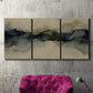 Three-panel canvas wall art featuring calm abstract water surface stillness, displayed in a living room above a suede accent chair.