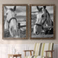 Set of two walnut barnwood framed canvas prints depicting two modern equestrian photography featuring black-and-white close-up portraits of horses at fences above a sideboard in a cozy sitting room.