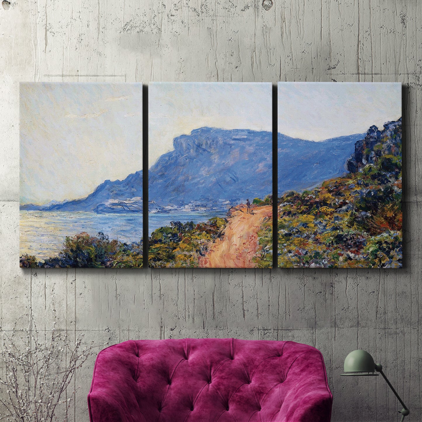 Three-panel canvas wall art featuring winding coastal road above sea, displayed in a living room above a suede accent chair.