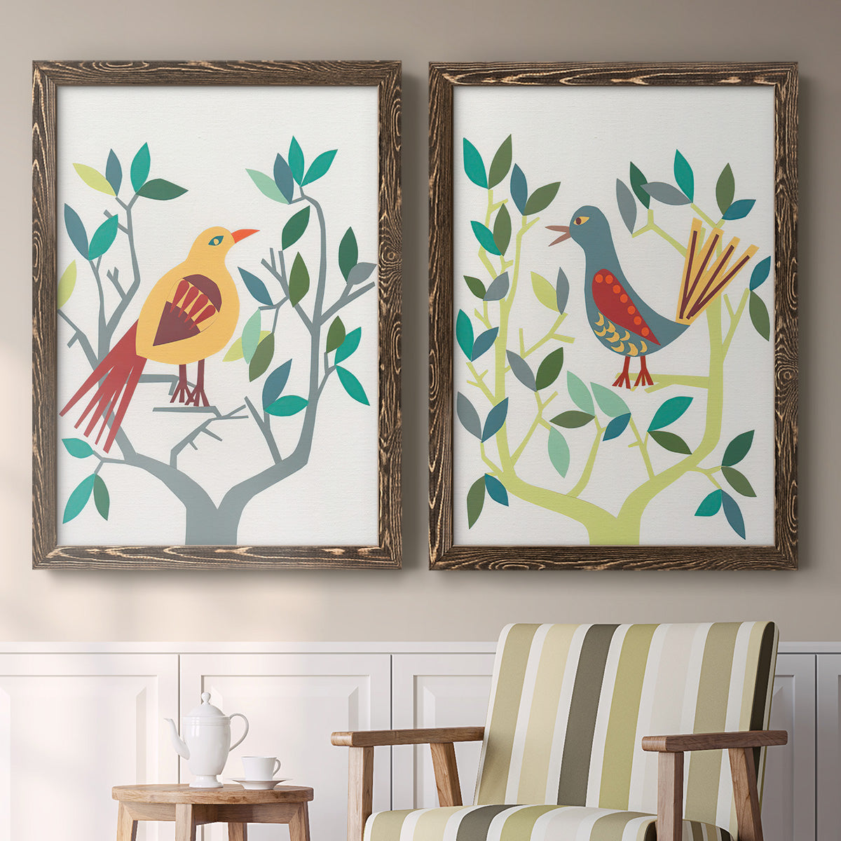 Set of two walnut barnwood framed canvas prints depicting two modern folk-art bird illustrations featuring stylized colorful birds perched among leafy branches above a sideboard in a cozy sitting room.