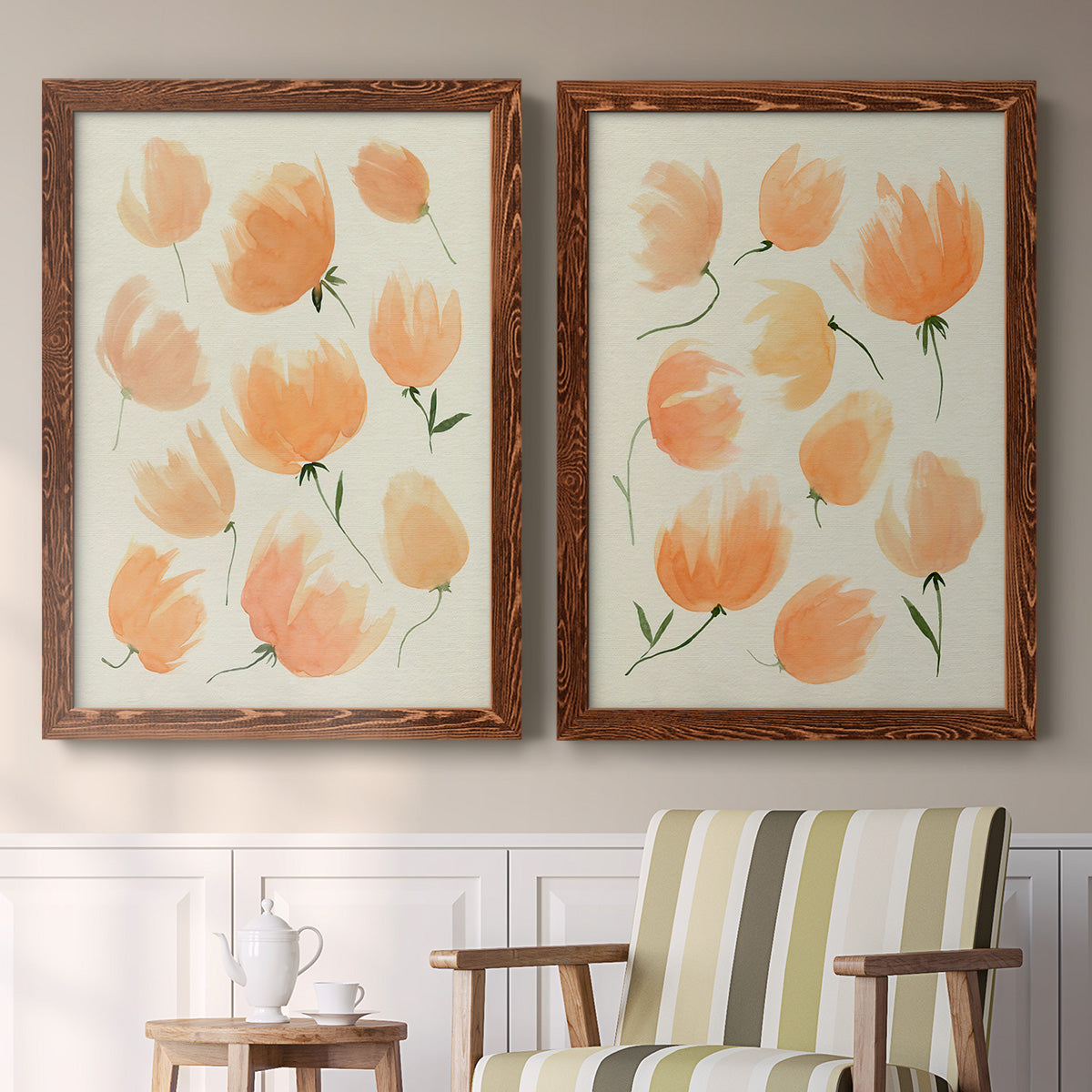 Set of two maple barnwood framed canvas prints depicting two airy watercolor floral paintings featuring loose peach-orange tulip-like blossoms above a sideboard in a cozy sitting room.