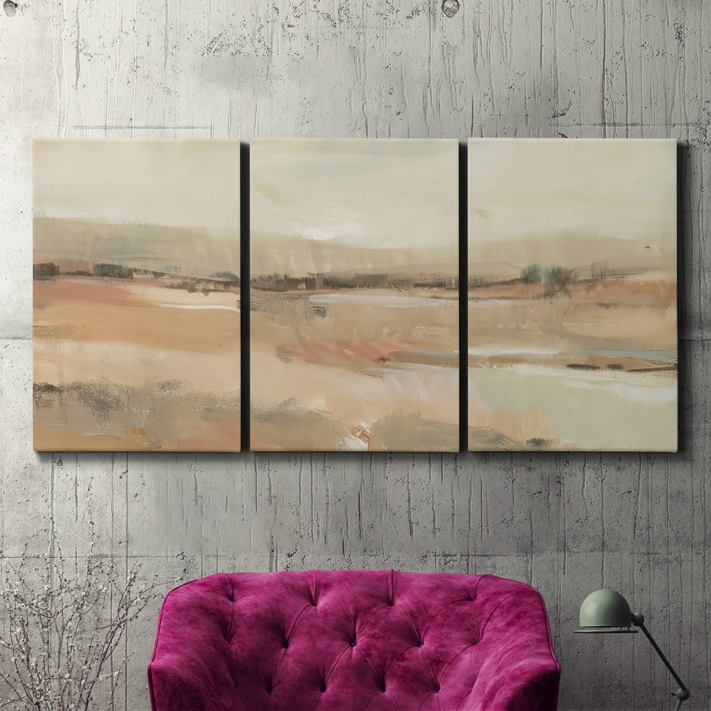 Three-panel canvas wall art featuring earth toned abstract landscape, displayed in a living room above a suede accent chair.