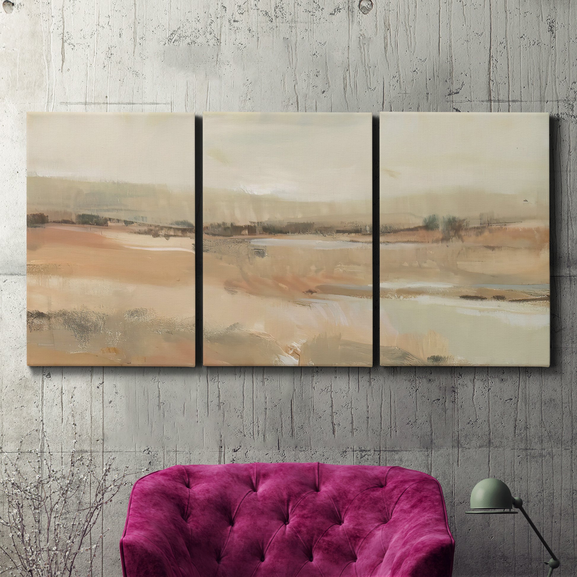 Three-panel canvas wall art featuring earth toned abstract landscape, displayed in a living room above a suede accent chair.