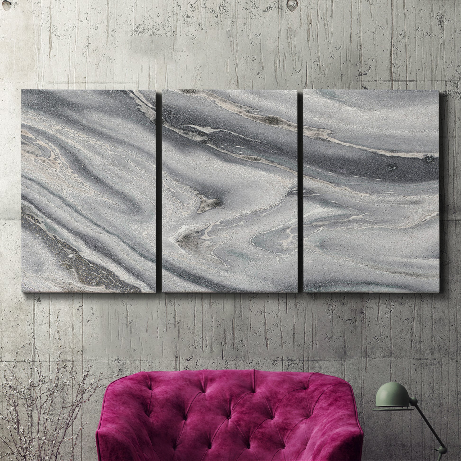 Three-panel canvas wall art featuring minimal monochrome abstract forms, displayed in a living room above a suede accent chair.