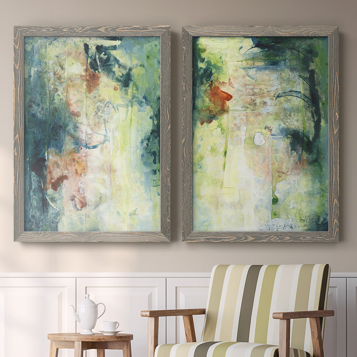 Set of two gray barnwood framed canvas prints depicting two nature-inspired mixed-media abstracts featuring layered blue green cream and charcoal textures above a sideboard in a cozy sitting room.