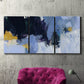 Three-panel canvas wall art featuring icy abstract arctic ledge, displayed in a living room above a suede accent chair.