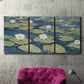 Three-panel canvas wall art featuring water lilies floating on pond, displayed in a living room above a suede accent chair.
