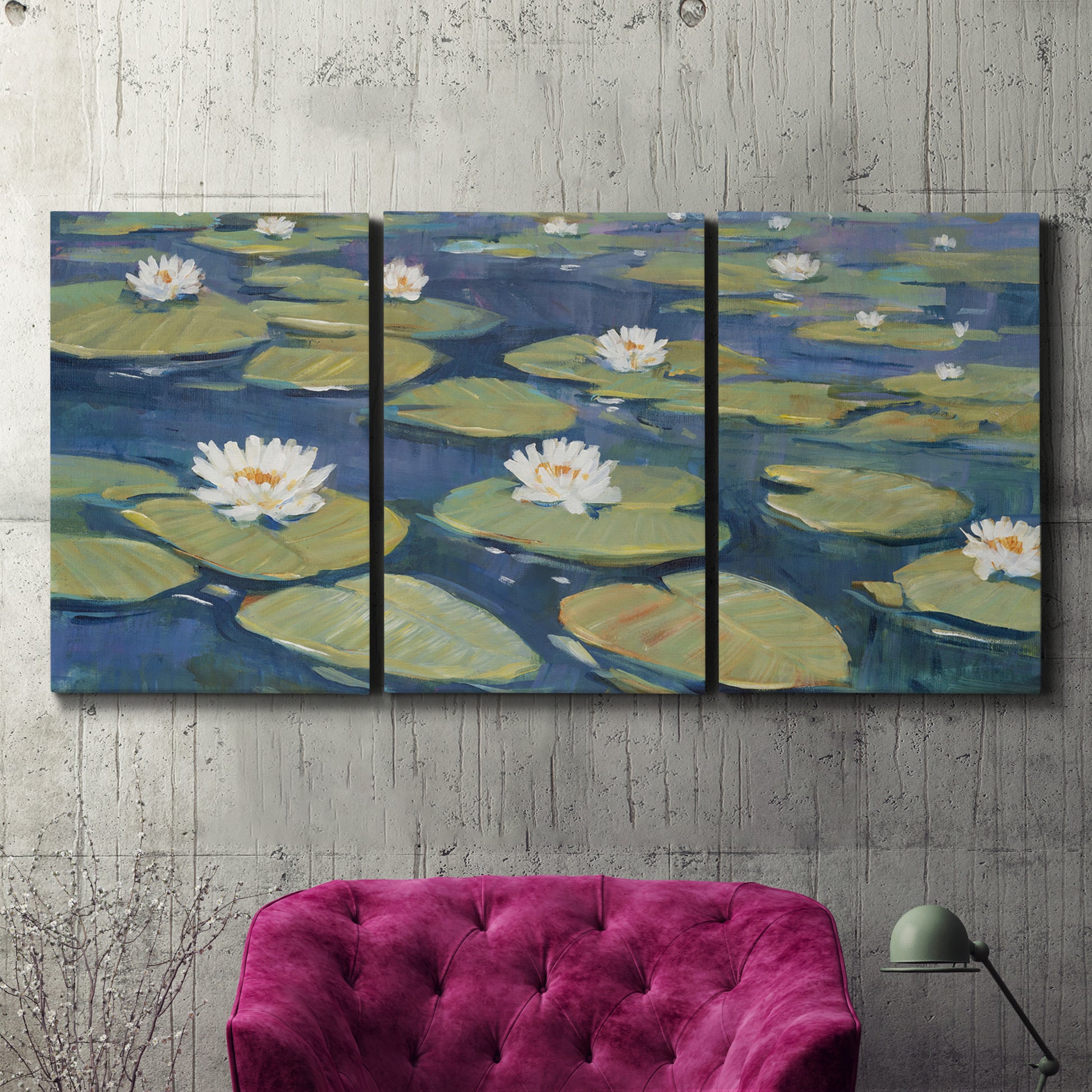 Three-panel canvas wall art featuring water lilies floating on pond, displayed in a living room above a suede accent chair.