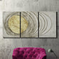 Three-panel canvas wall art featuring circular abstract energy forms, displayed in a living room above a suede accent chair.