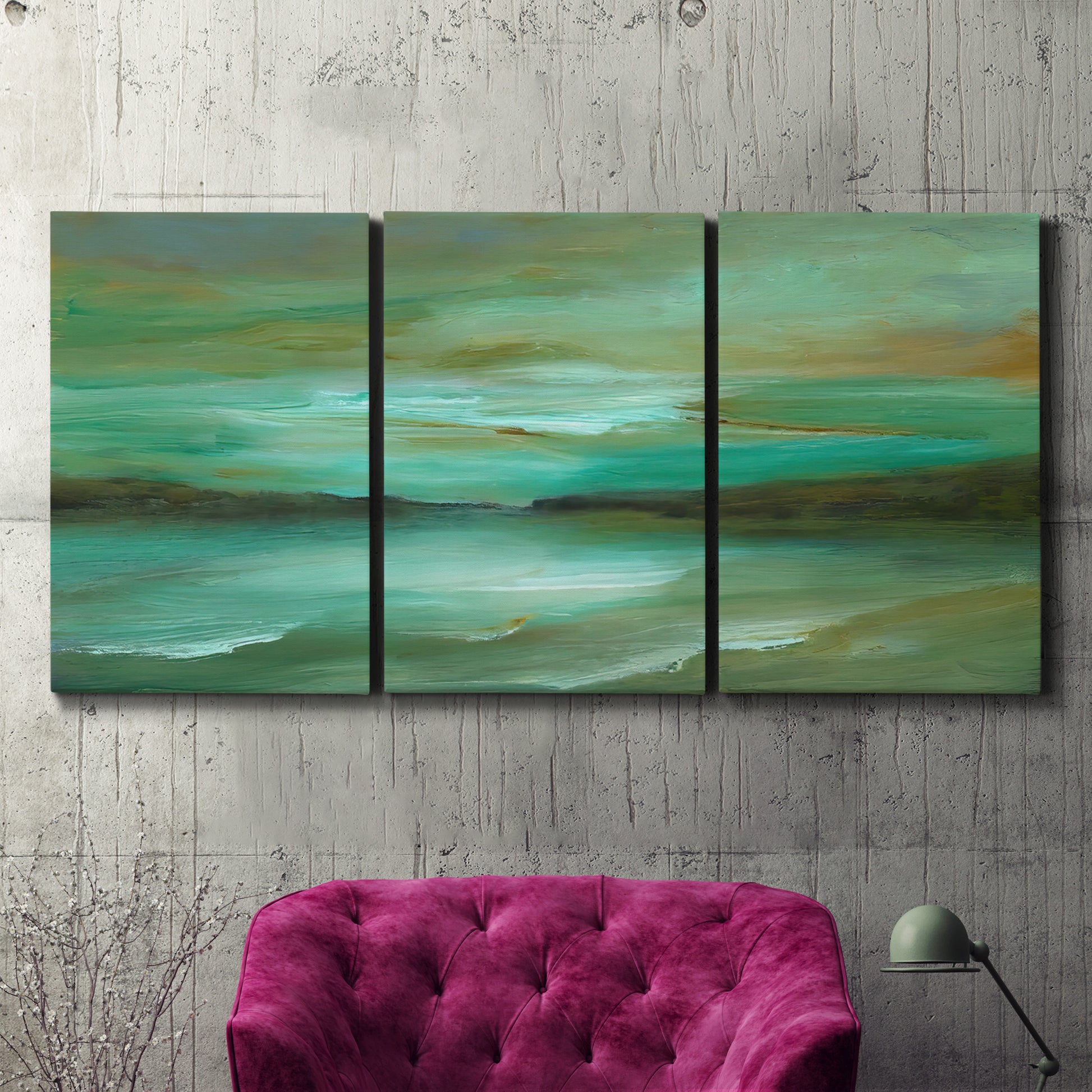 Three-panel canvas wall art featuring hidden coastal cove landscape, displayed in a living room above a suede accent chair.