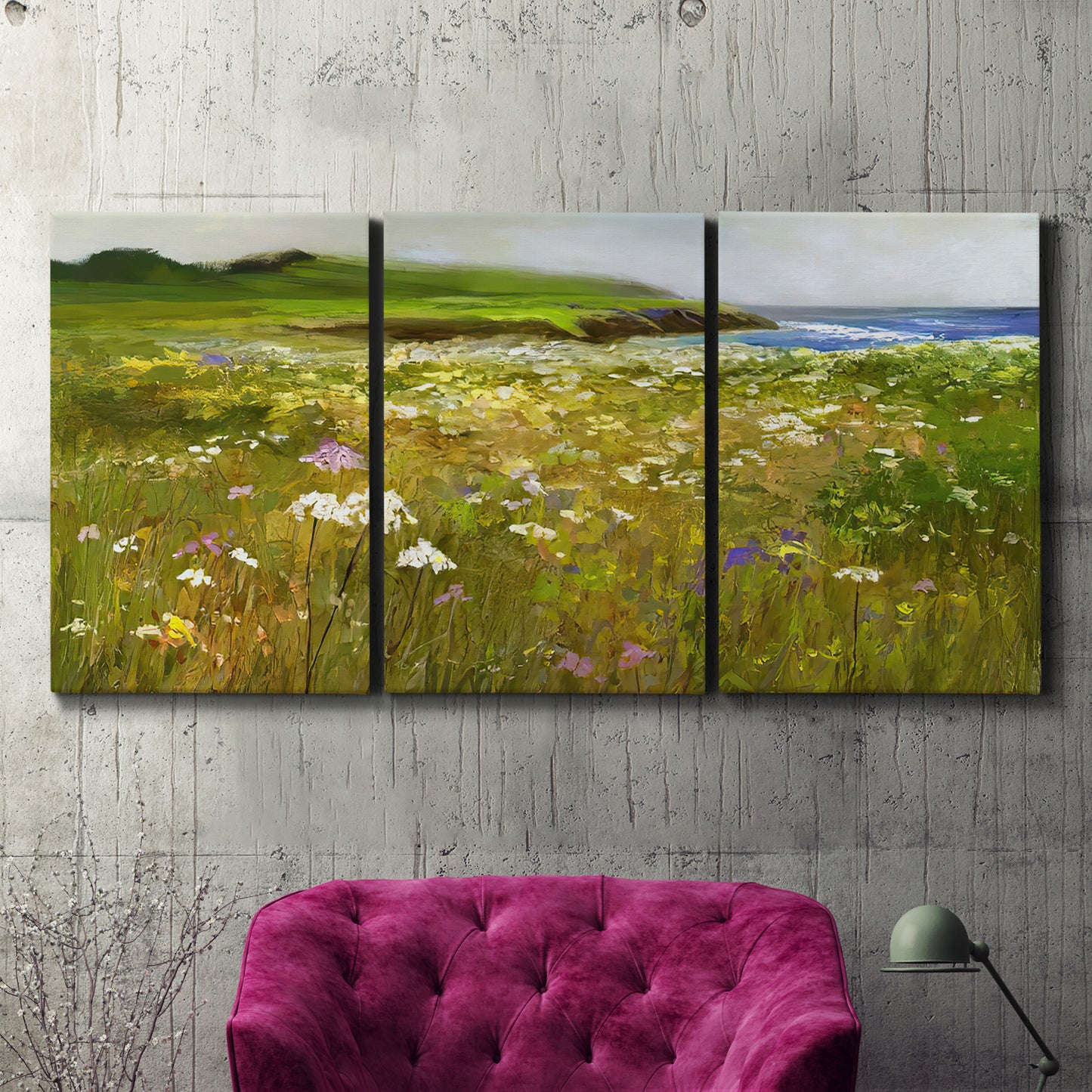 Three-panel canvas wall art featuring rugged coastal cliff landscape, displayed in a living room above a suede accent chair.