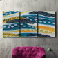 Three-panel canvas wall art featuring feather inspired abstract linear motion, displayed in a living room above a suede accent chair.