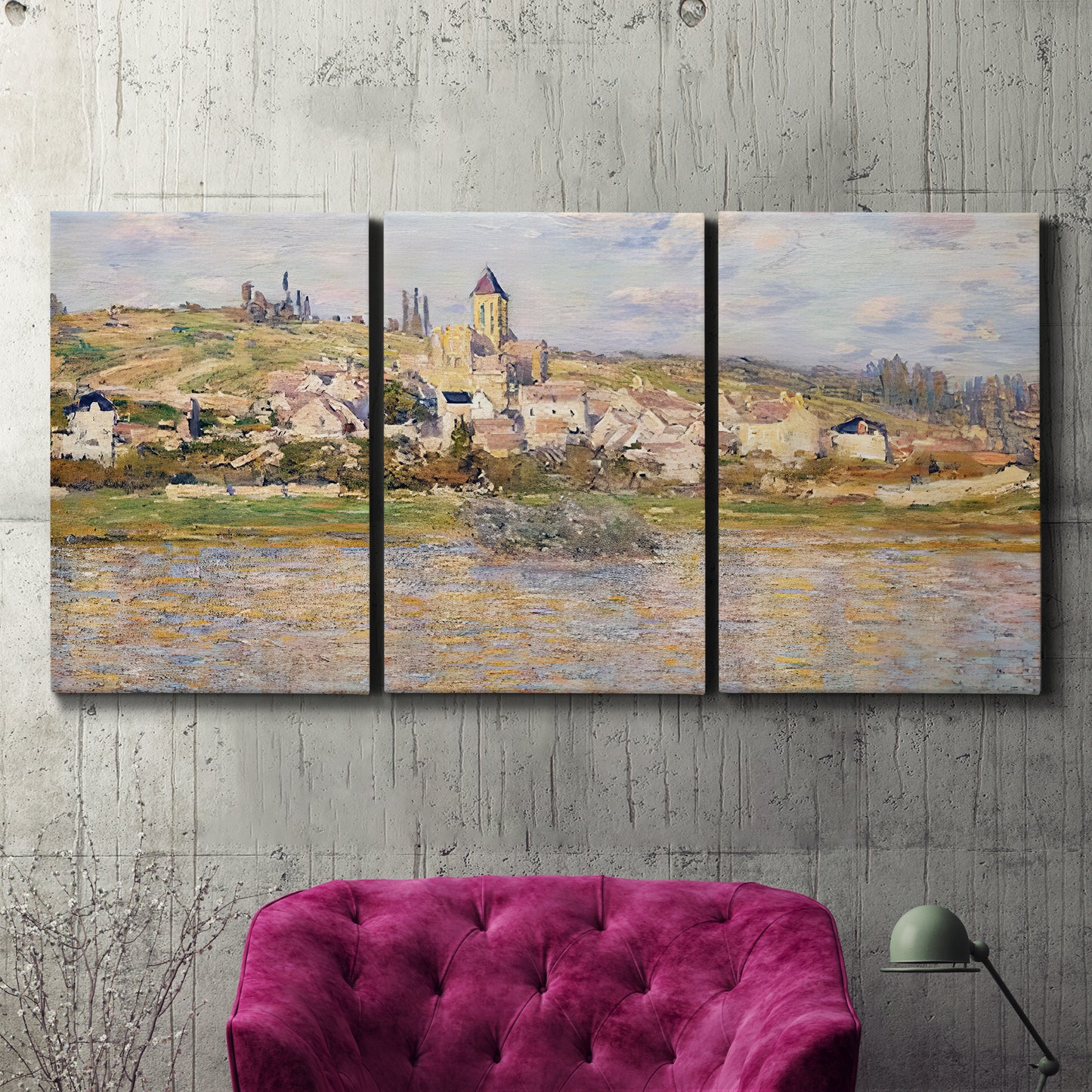 Three-panel canvas wall art featuring village overlooking river valley, displayed in a living room above a suede accent chair.