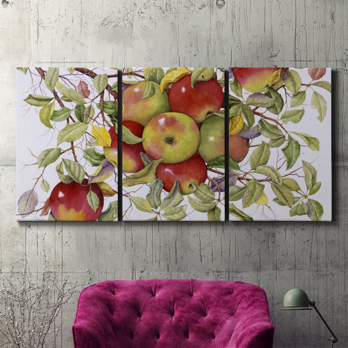 Three-panel canvas wall art featuring apples hanging from branch, displayed in a living room above a suede accent chair.