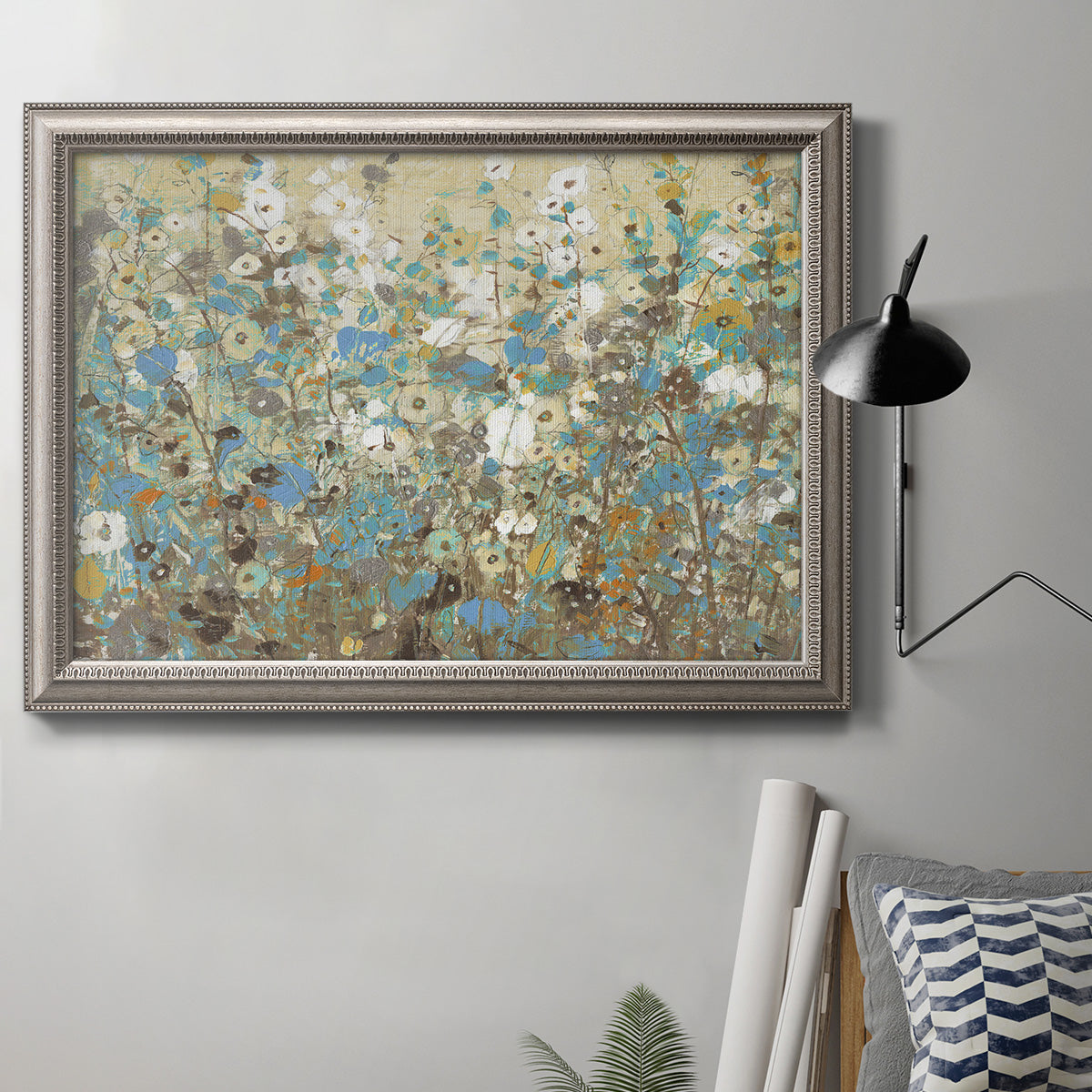 Impressionist flowering vine watercolor artwork in an ornate vintage silver frame displayed in a neutral interior setting.