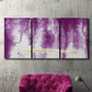 Three-panel canvas wall art featuring saturated abstract color fields, displayed in a living room above a suede accent chair.