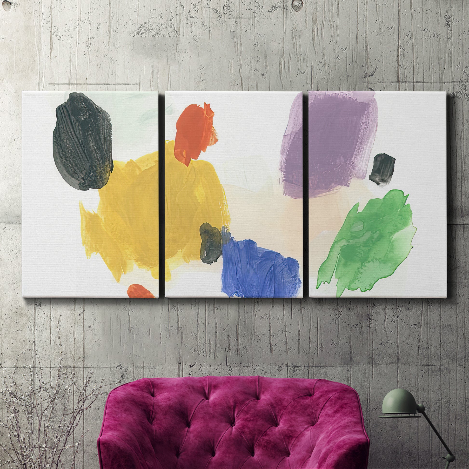 Three-panel canvas wall art featuring inkblot style abstract color symmetry, displayed in a living room above a suede accent chair.