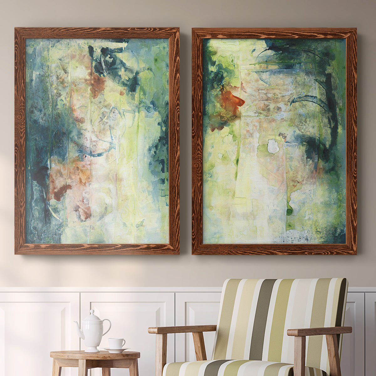 Set of two maple barnwood framed canvas prints depicting two nature-inspired mixed-media abstracts featuring layered blue green cream and charcoal textures above a sideboard in a cozy sitting room.