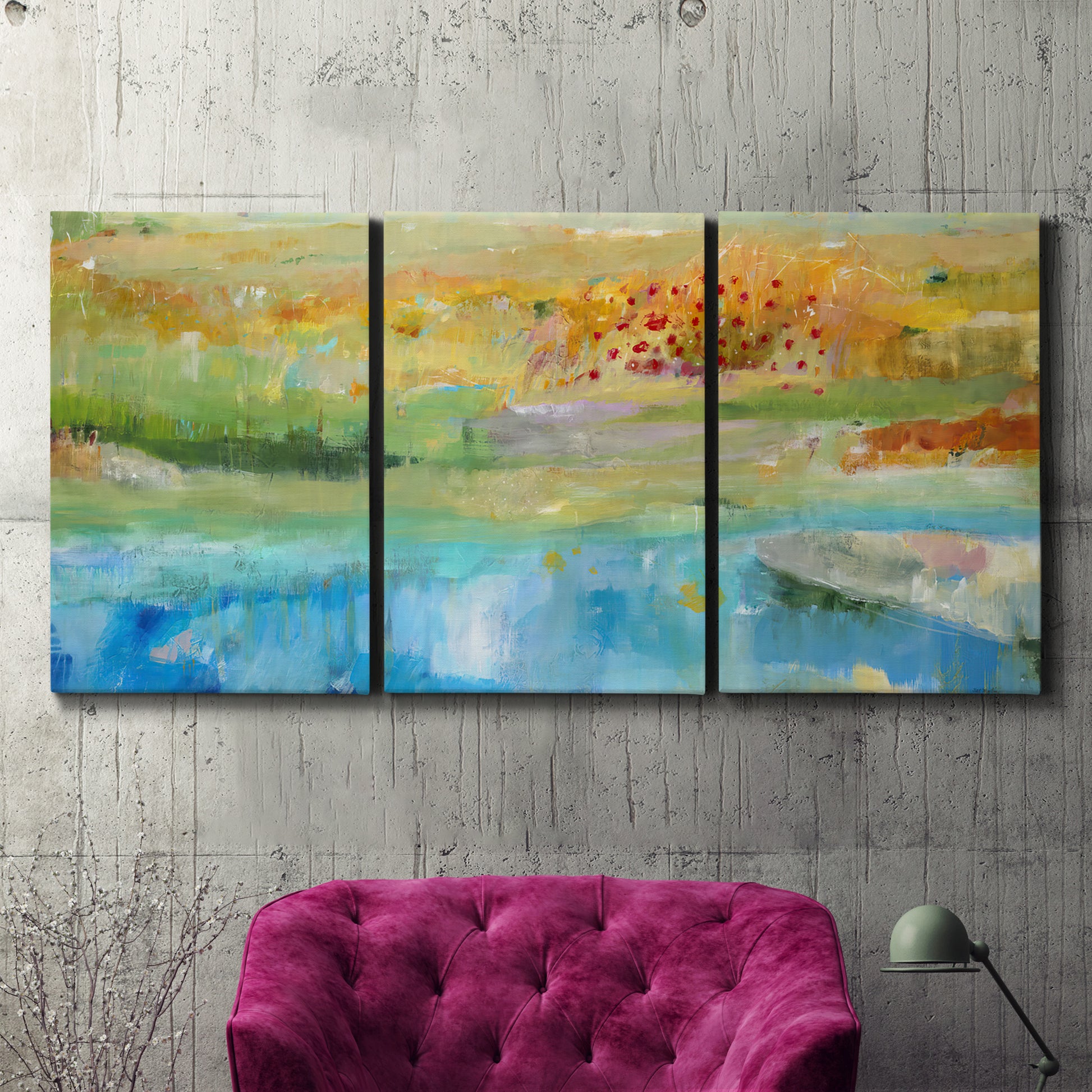 Three-panel canvas wall art featuring abstract sense of forward movement, displayed in a living room above a suede accent chair.
