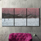 Three-panel canvas wall art featuring winter sunset snowfall landscape, displayed in a living room above a suede accent chair.