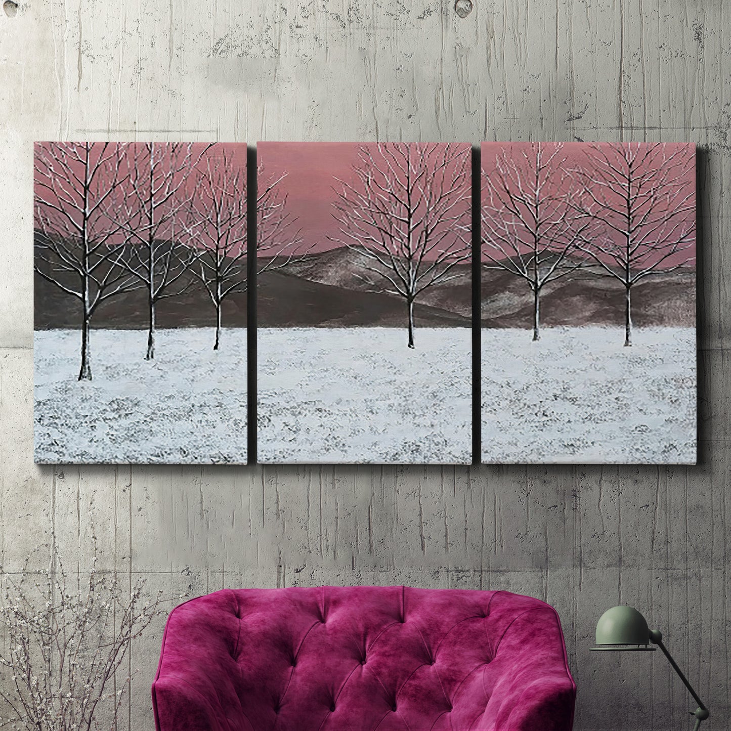 Three-panel canvas wall art featuring winter sunset snowfall landscape, displayed in a living room above a suede accent chair.