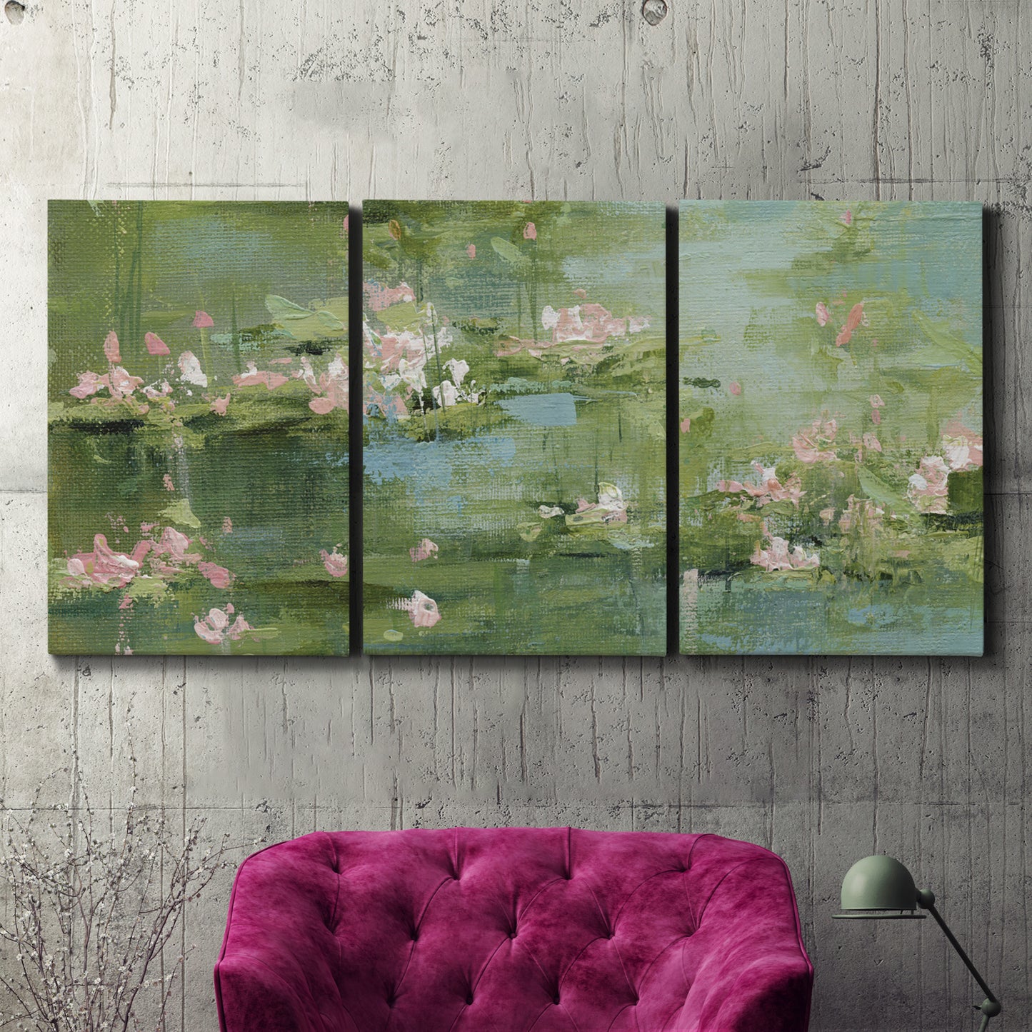 Three-panel canvas wall art featuring soft green water lilies, displayed in a living room above a suede accent chair.