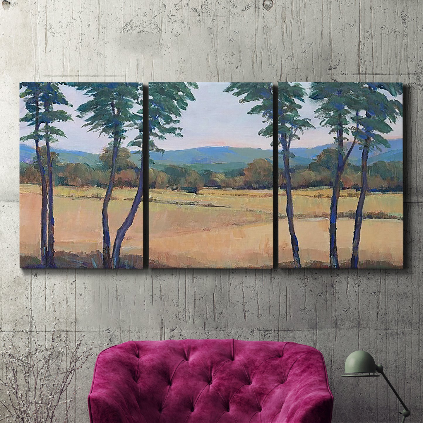 Three-panel canvas wall art featuring quiet morning landscape with trees, displayed in a living room above a suede accent chair.