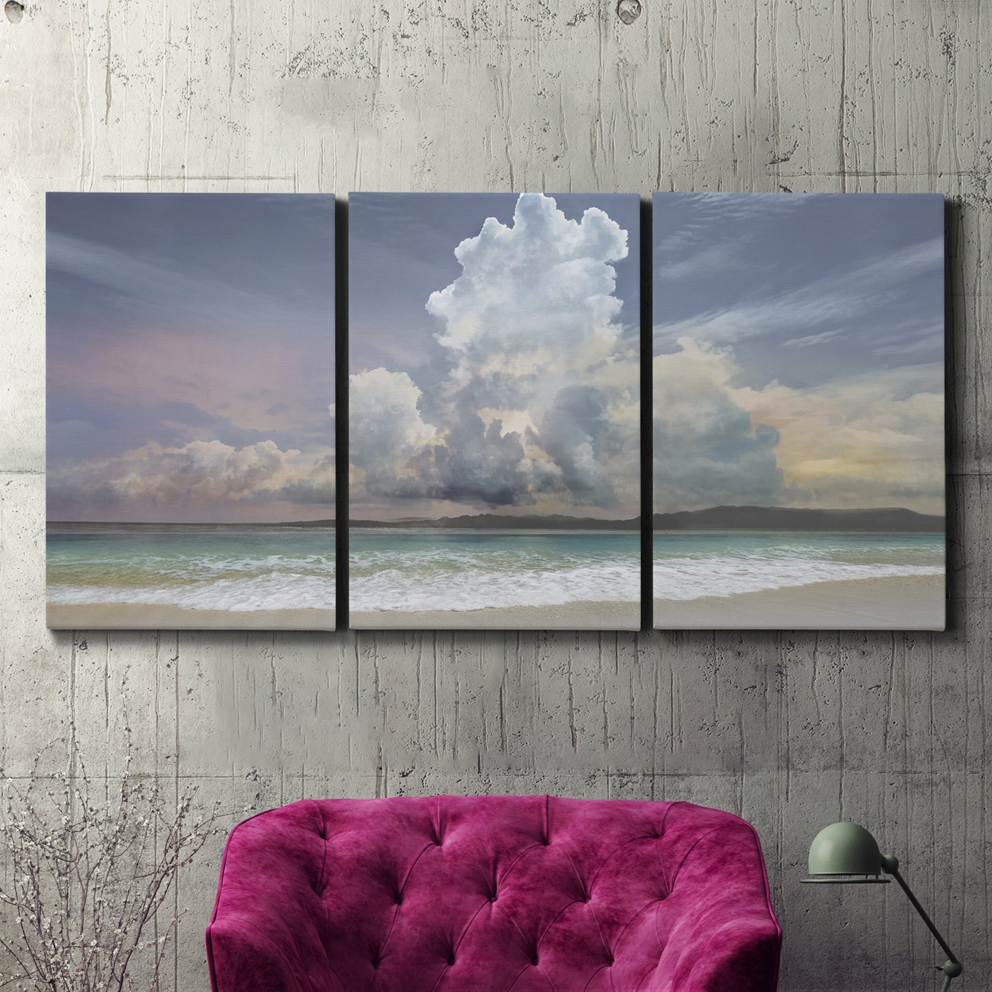 Three-panel canvas wall art featuring rain falling on sandy beach, displayed in a living room above a suede accent chair.