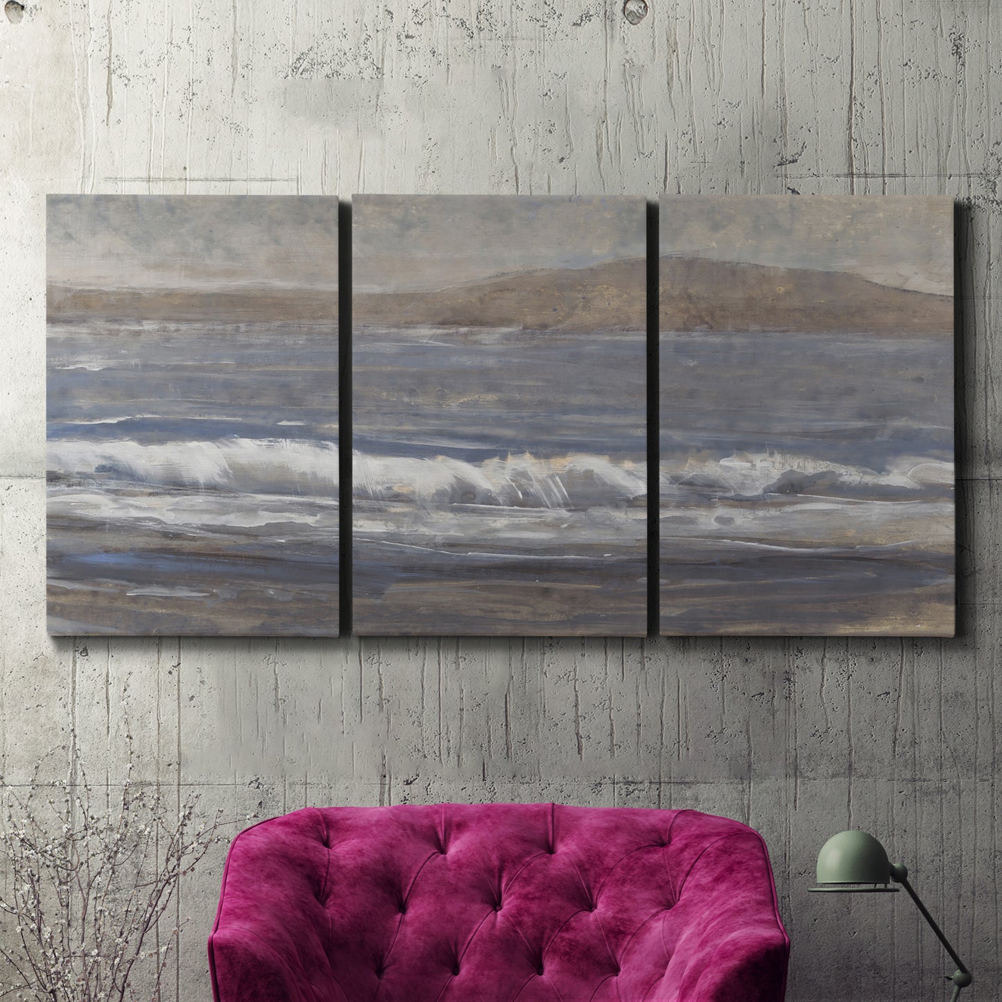 Three-panel canvas wall art featuring shoreline between land and sea, displayed in a living room above a suede accent chair.