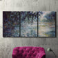 Three-panel canvas wall art featuring misty river scene in morning light, displayed in a living room above a suede accent chair.