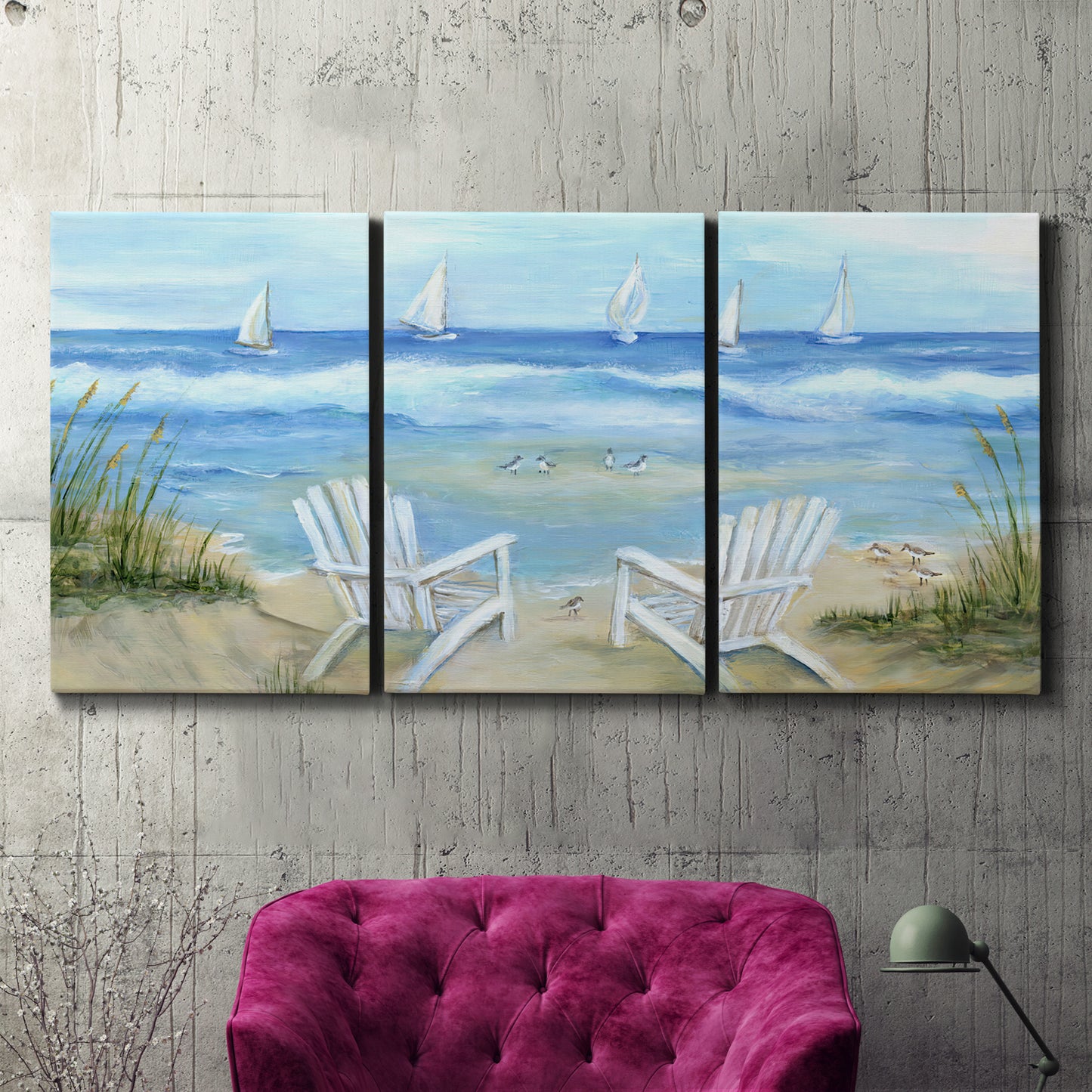 Three-panel canvas wall art featuring peaceful coastal landscape escape, displayed in a living room above a suede accent chair.