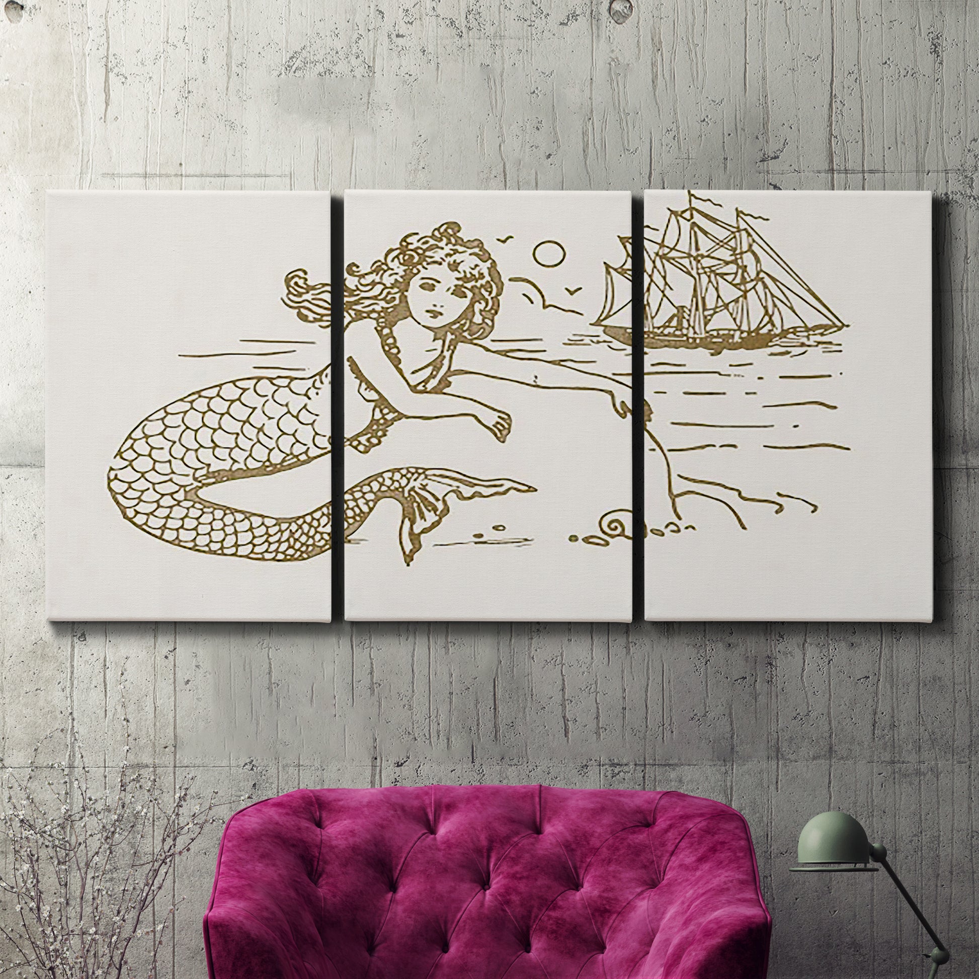 Three-panel canvas wall art featuring whimsical mermaid resting by sea, displayed in a living room above a suede accent chair.