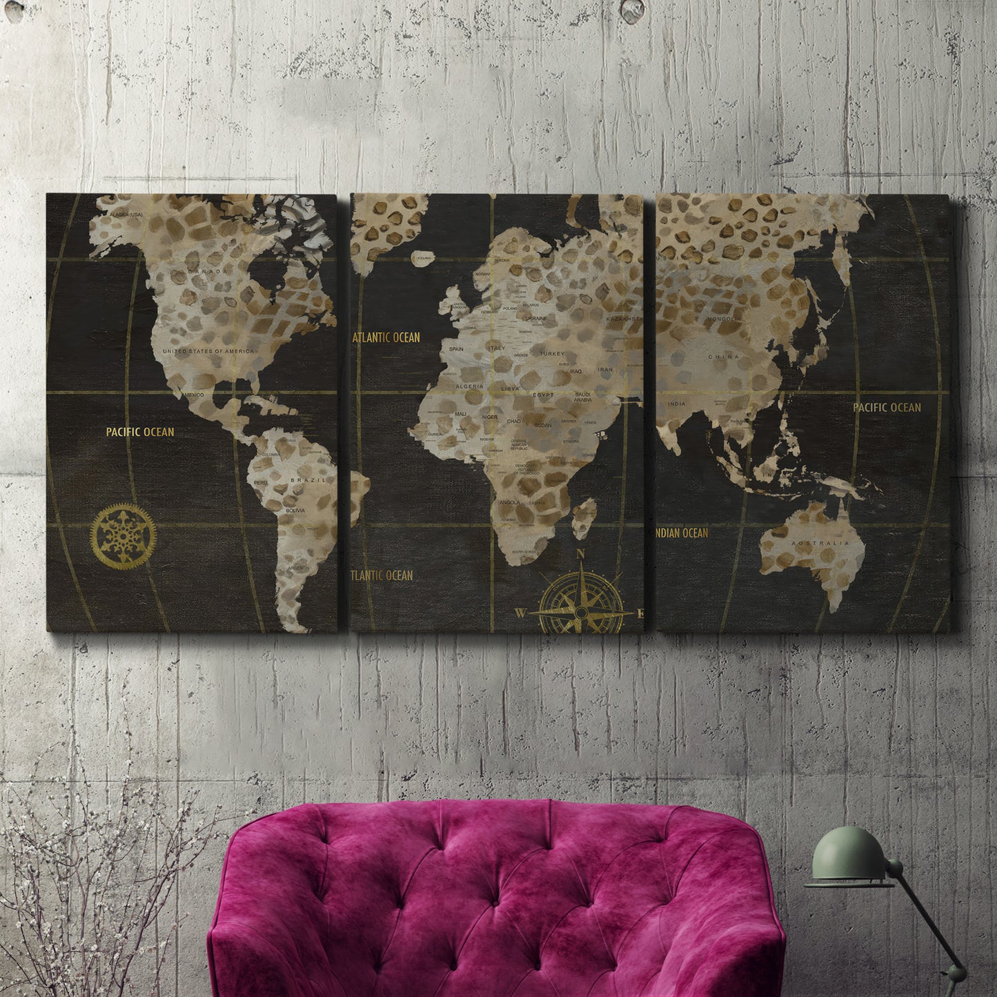 Three-panel canvas wall art featuring illustrated safari world map, displayed in a living room above a suede accent chair.