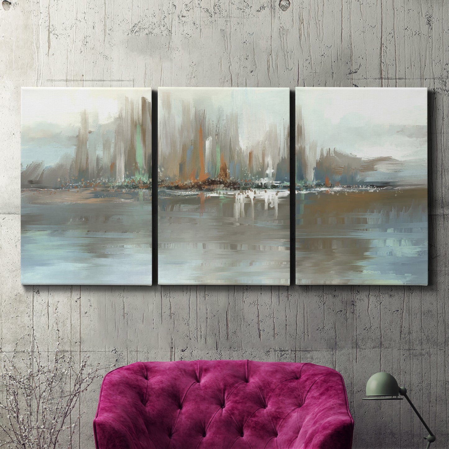 Three-panel canvas wall art featuring glowing abstract city lights, displayed in a living room above a suede accent chair.