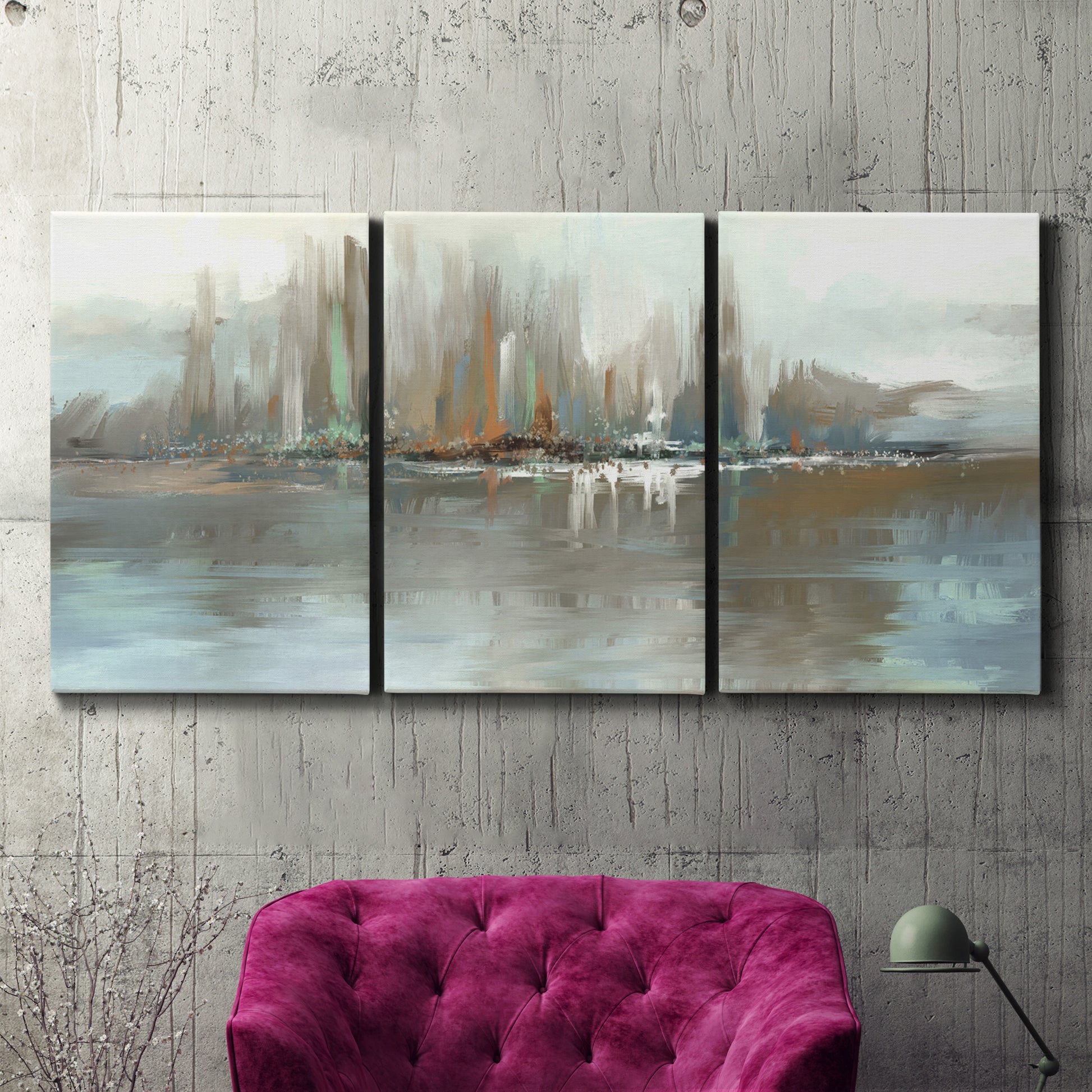 Three-panel canvas wall art featuring glowing abstract city lights, displayed in a living room above a suede accent chair.
