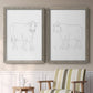Set of two gray barnwood framed canvas prints depicting two minimalist livestock sketches featuring simple contour drawings of standing cows above a sideboard in a cozy sitting room.