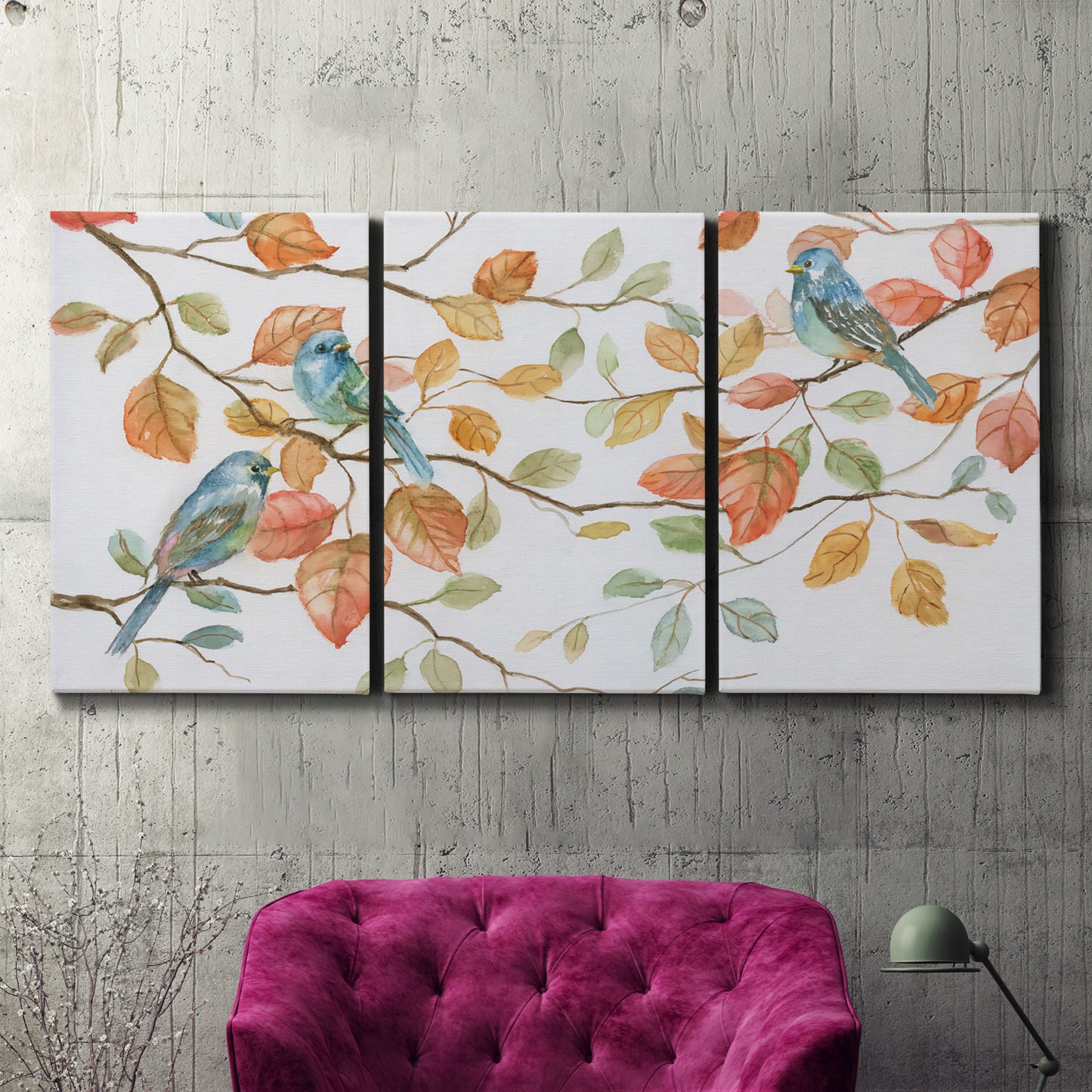 Three-panel canvas wall art featuring decorative bird trio illustration, displayed in a living room above a suede accent chair.
