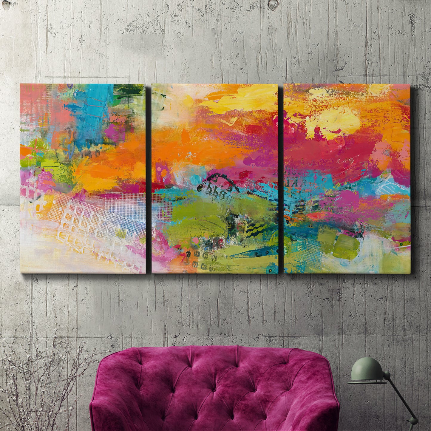 Three-panel canvas wall art featuring expressive abstract sunset tones, displayed in a living room above a suede accent chair.
