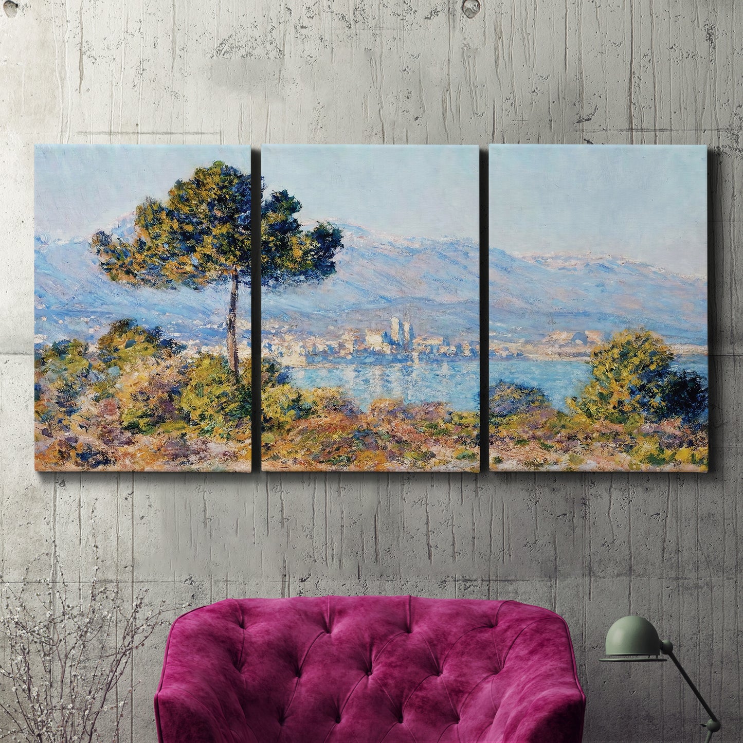 Three-panel canvas wall art featuring coastal town viewed from hillside, displayed in a living room above a suede accent chair.
