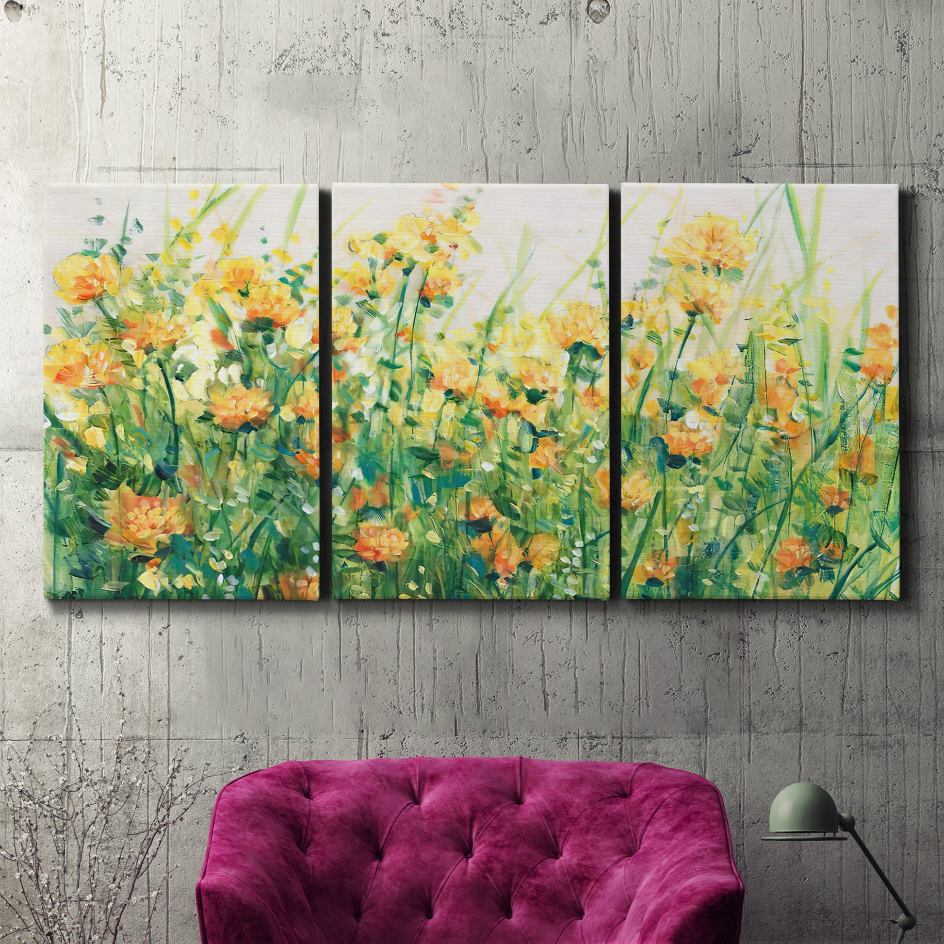 Three-panel canvas wall art featuring colorful garden flowers in bloom, displayed in a living room above a suede accent chair.