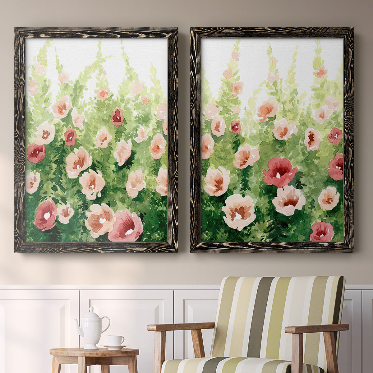 Set of two black barnwood framed canvas prints depicting two luminous impressionistic floral paintings featuring a field of pink coral and white flowers above a sideboard in a cozy sitting room.