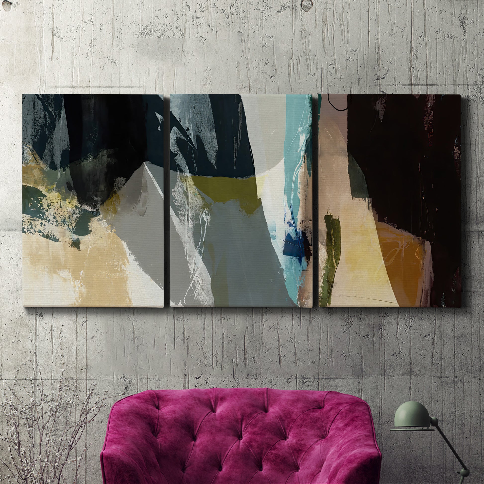 Three-panel canvas wall art featuring layered neutral abstract textures, displayed in a living room above a suede accent chair.