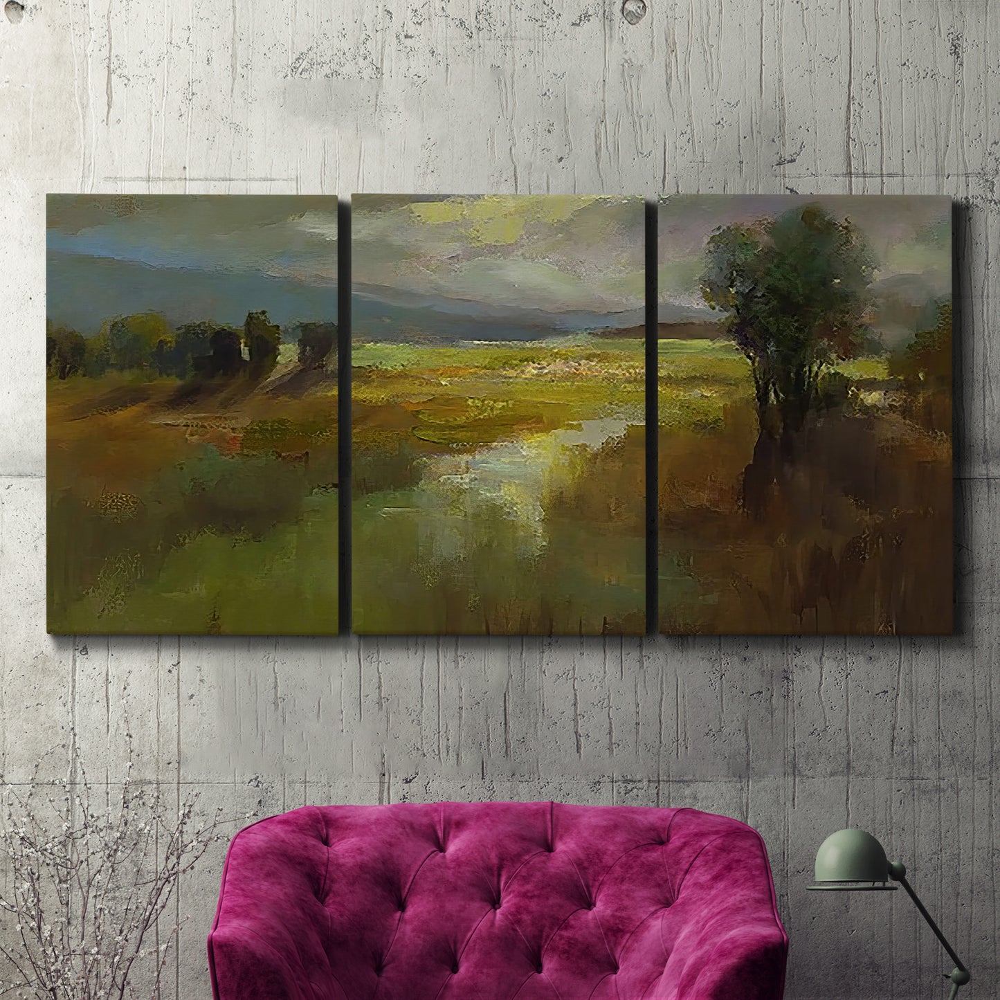 Three-panel canvas wall art featuring winding rural road through countryside, displayed in a living room above a suede accent chair.